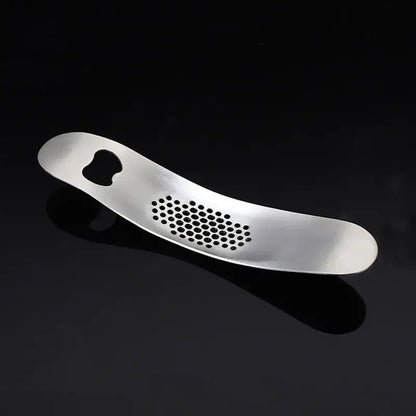 Silver stainless steel decorbites garlic press with sleek curved design and evenly spaced circular holes for easy crushing