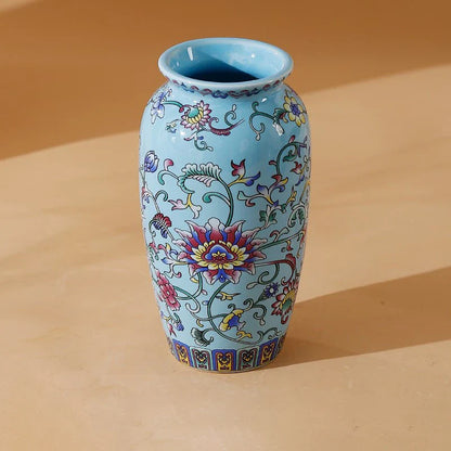 A light blue small ceramic vase with intricate colorful floral patterns made of enamel glazed porcelain for home