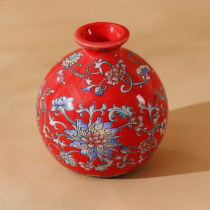 Small vibrant red ceramic vase with intricate blue pink and white floral patterns for elegant vintage home decor