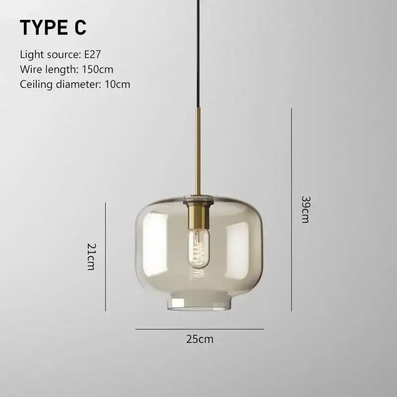 Smoked glass pendant light with frosted globe and brass accents featuring an exposed edison bulb for dining room