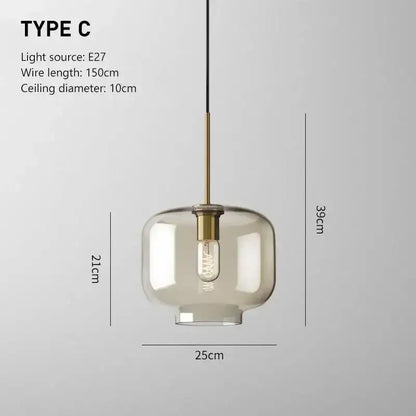 Smoked glass pendant light with frosted globe and brass accents featuring an exposed edison bulb for dining room