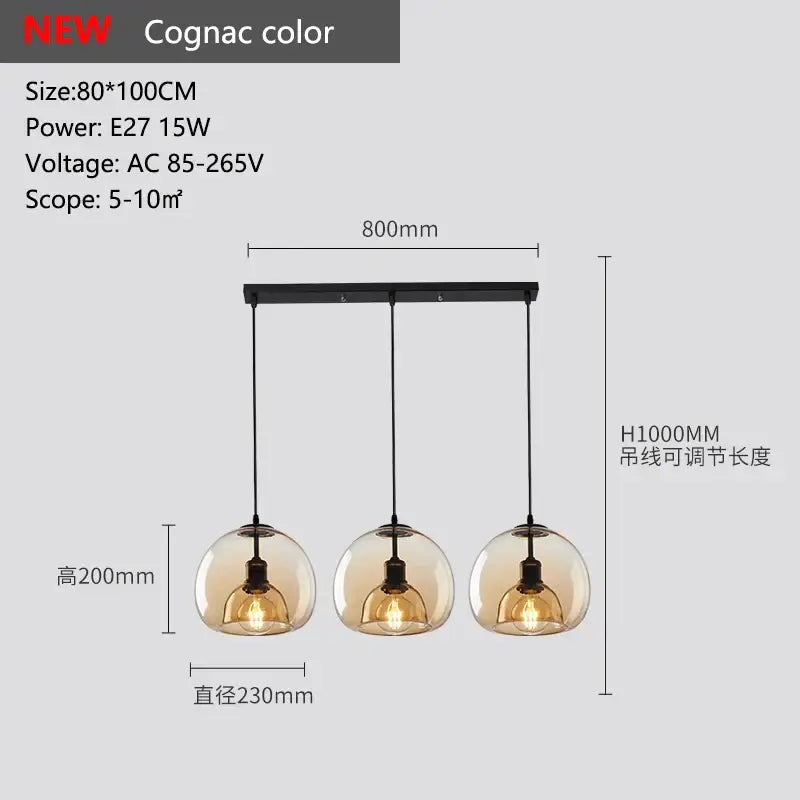 Smoked glass pendant lights trio featuring cognac-colored glass pendant shades with black metal fixtures for dining room