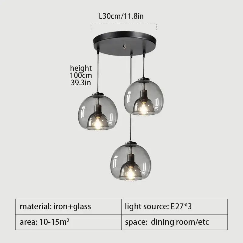 Modern three-bulb pendant lights with smoked glass globes and matte black iron mount for dining room table