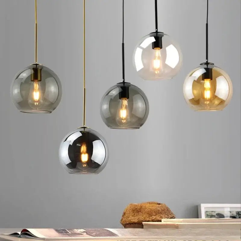 Smoky gray five light glass globe pendant light with iron finish hanging from black and gold cords as light source
