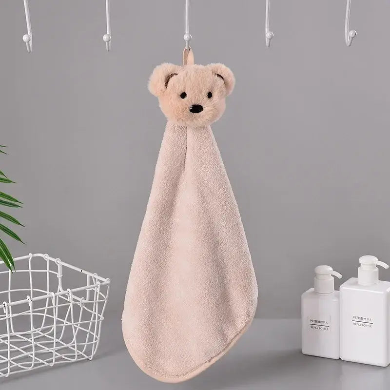 Soft blush-pink plush cartoon bear hand towel with black embroidered eyes made of microfiber for kitchen and bathroom use