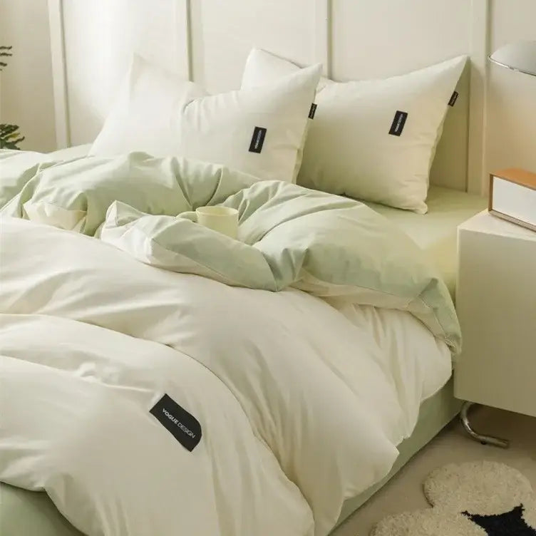 Soft cream and mint green decorbites cotton bedding set with subtle black brand tags on duvet cover and pillowcases