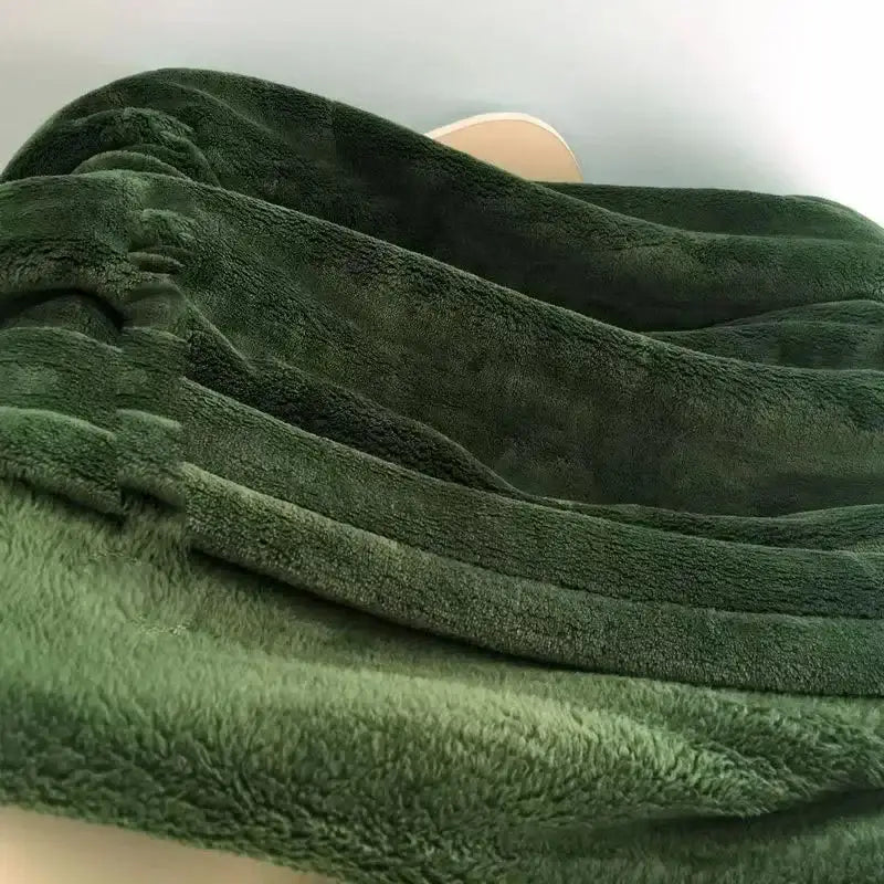 A plush deep green fleece blanket with a soft textured surface perfect as a decorbites cozy flannel warm shawl