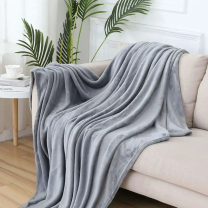 A soft gray cozy flannel warm blanket draped over a beige sofa for plush decorbites cozy flannel comfort