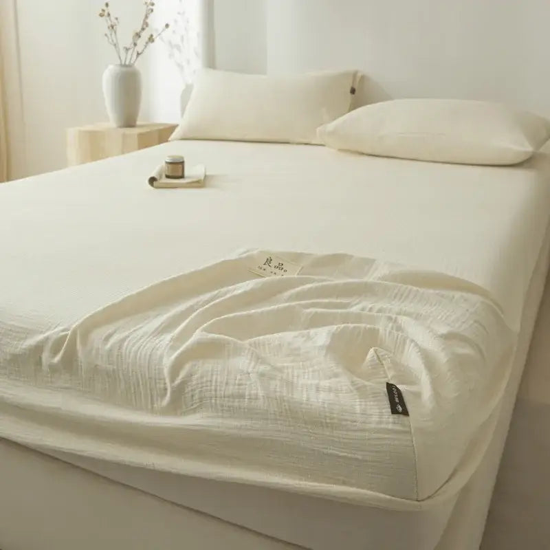 Soft light gray decorbites cotton fitted sheet with a cream-colored subtle textured weave and neatly folded edges