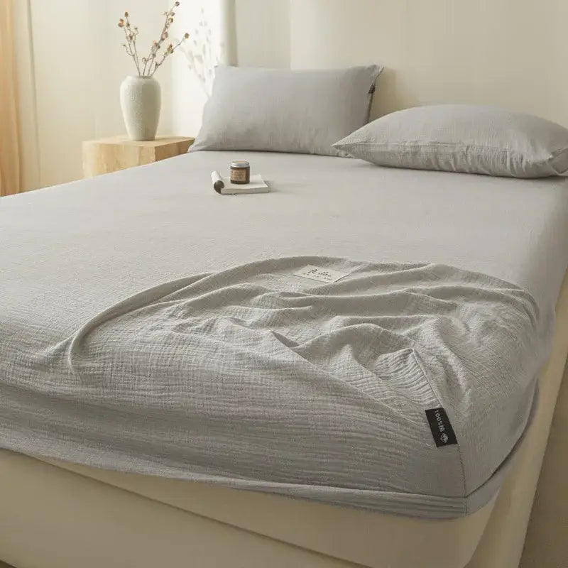 Soft light gray decorbites cotton fitted sheet with textured crinkled finish and neatly folded edges for bedroom use