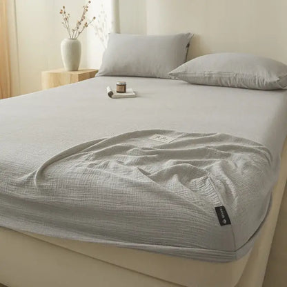 Soft light gray decorbites cotton fitted sheet with textured crinkled finish and neatly folded edges for bedroom use