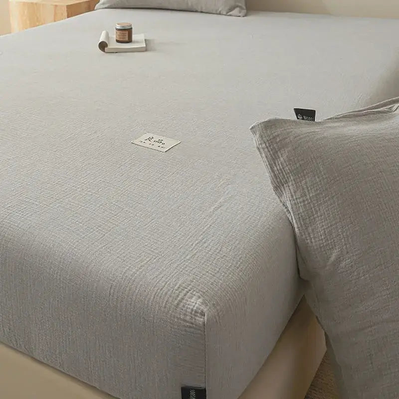 Soft light gray cotton fitted sheet with subtle woven pattern and white label for bedroom decorbites cotton fitted use