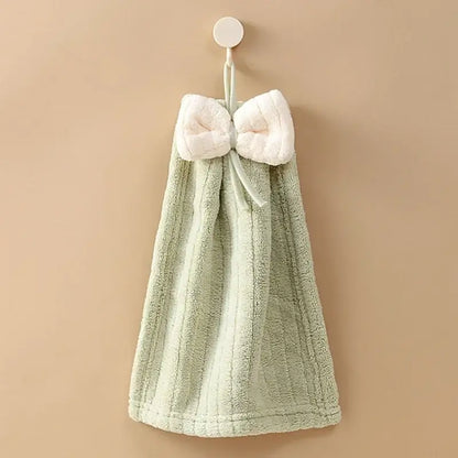 A soft mint green hand towel with a plush white bowknot made of decorbites bowknot microfiber for kitchen and bathroom use