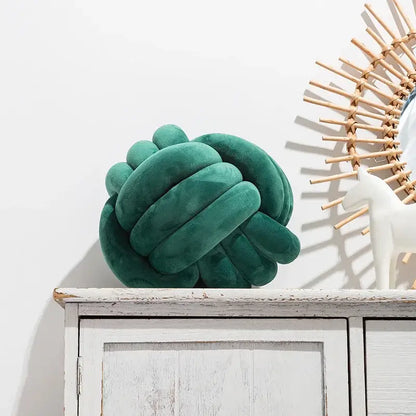 Emerald green velvet knotted ball round cushion featuring a soft pink velvet knotted ball design for bedroom decor
