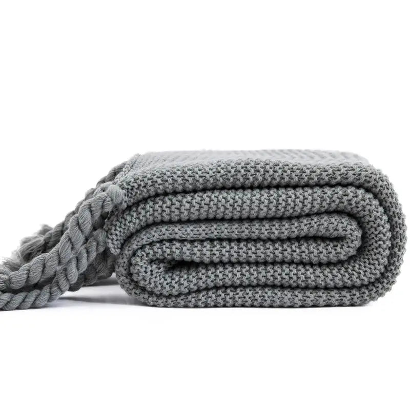 Soft medium-gray decorbites knit throw blanket with textured weave and thick braided tassel for cozy decor