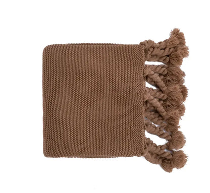 A cozy earthy brown decorbites knit throw blanket with textured weave and tassels for soft plaid decor accents