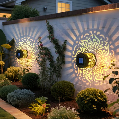 Golden solar-powered datura lantern wall lamp with intricate patterns and black accents for outdoor garden decor