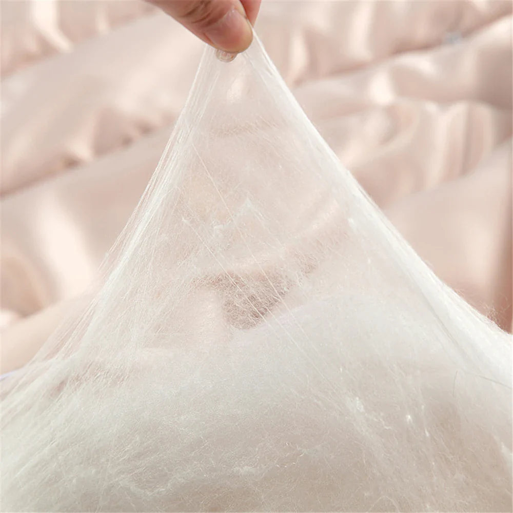 A delicate white silk quilt made of natural 100% silk fabric gently stretched by a hand for soft comfort