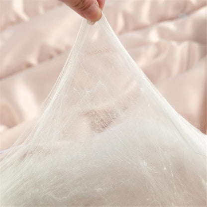 A delicate white silk quilt made of natural 100% silk fabric gently stretched by a hand for soft comfort