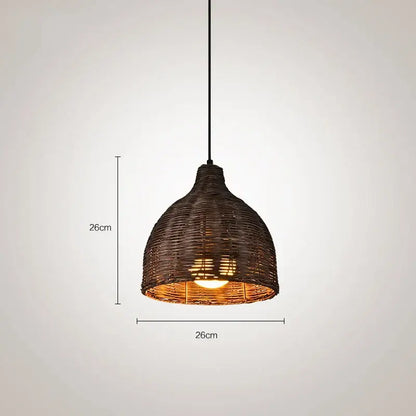 Dark brown woven rattan pendant light with warm glowing bulb for Southeast Asia natural dining room decor
