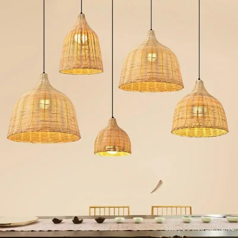 Natural dark brown woven rattan pendant light with warm golden glow ideal for southeast asia dining room ambiance
