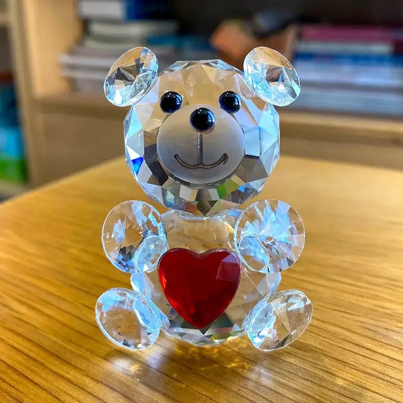 A sparkling crystal bear figurine with black bead eyes holding a red heart for bedroom decor by decorbites