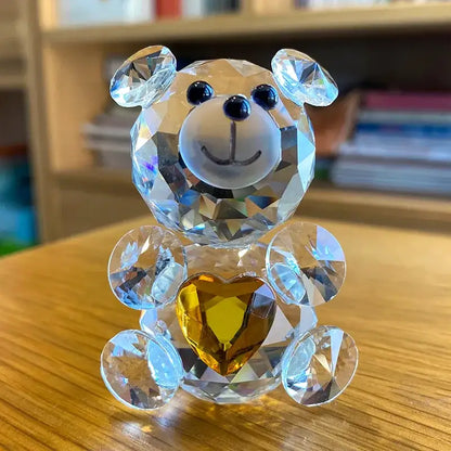 Sparkling crystal bear figurine with faceted clear body and black eyes holding golden heart decorbites crystal bear