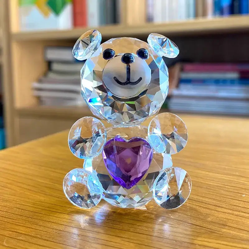 A sparkling decorbites crystal bear figurine with faceted body black bead eyes and a purple heart pendant for bedroom decor
