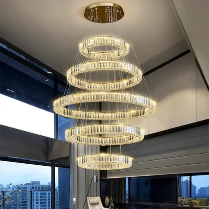 A decorbites crystal chandelier pendant light featuring multi-tiered spiral crystal rings with a gold ceiling mount