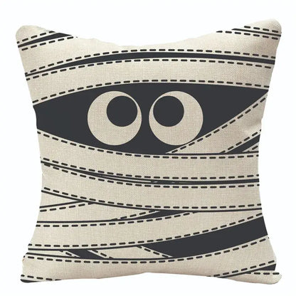 Beige halloween pumpkin linen cushion with black mummy wrap design and cartoon eyes for living room sofa
