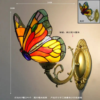 Vibrant stained glass butterfly wall sconce with gold-toned ornate metal mounting and curved arm for living room decorbites butterfly stained wall sconces