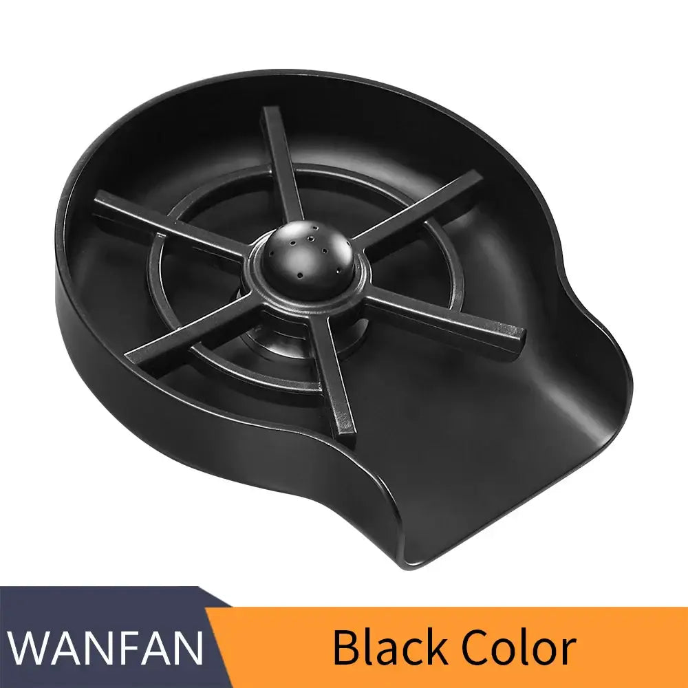 Black plastic sink drain catcher with central perforated sphere and radial arms for stainless steel glass rinser kitchen