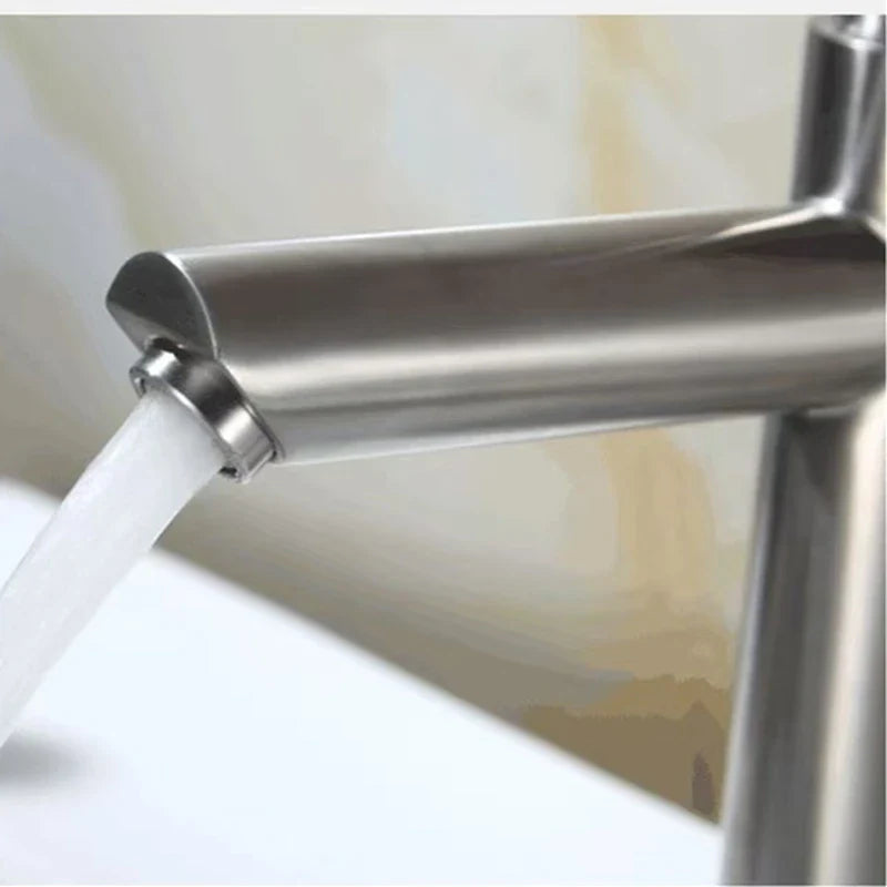 Modern brushed stainless steel single hole cold water tap with sleek cylindrical spout and curved handle for basin use