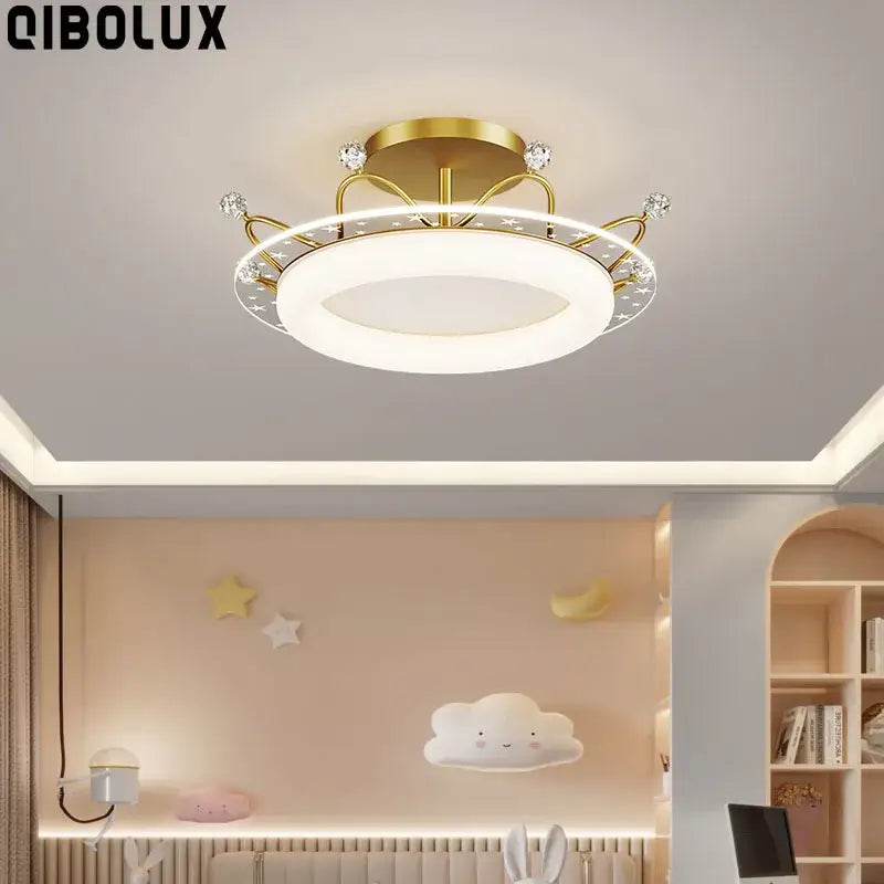 Gold-finished ceiling light with star pattern crystal accents in pink and blue for decorbites kids room ceiling use