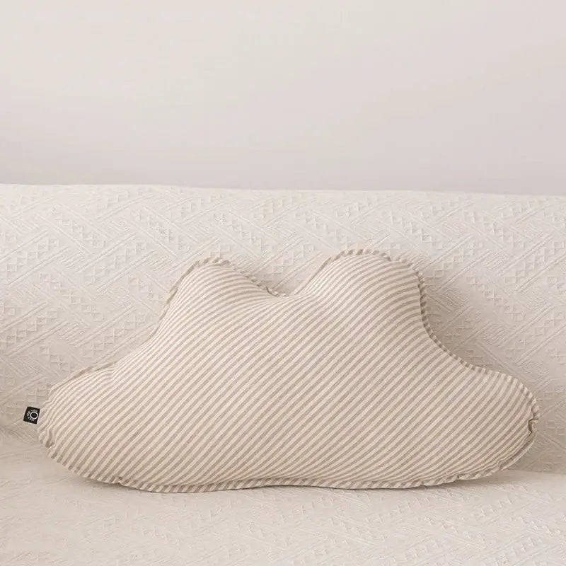 A soft cream-colored decorbites cloud star pillow with subtle diagonal stripes and gently stitched edges for kids bedroom