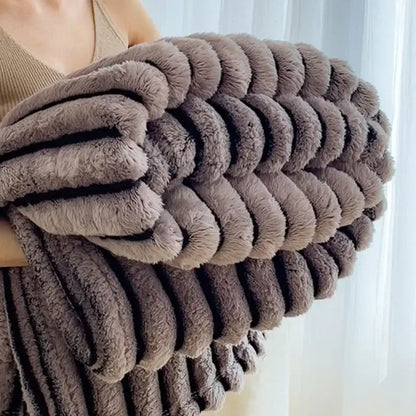 A taupe faux rabbit plush fleece blanket with ribbed texture featured in decorbites dark faux collection bedroom throw