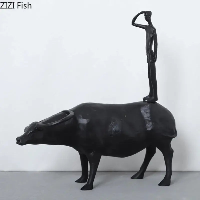 Stylized black matte metal cowherd shepherd boy sculpture standing atop a buffalo for living room decorbites decor