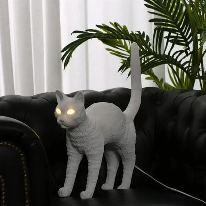 White ceramic table lamp with glowing yellow eyes from decorbites black cat resin bedroom decor collection