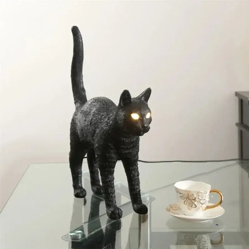 Stylized black and white cat resin table lamp with glowing amber eyes for bedroom decorbites black cat lighting