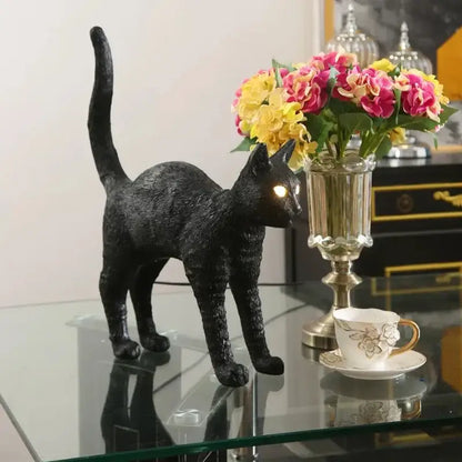 Stylized black and white cat resin table lamp with textured surface and glowing eyes perfect for bedroom decorbites black cat