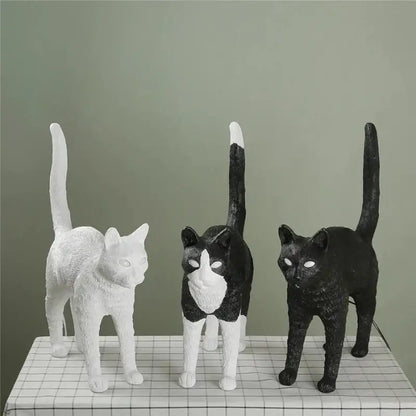 Three stylized cat resin table lamps in white black and white and solid black for bedroom decorbites black cat design
