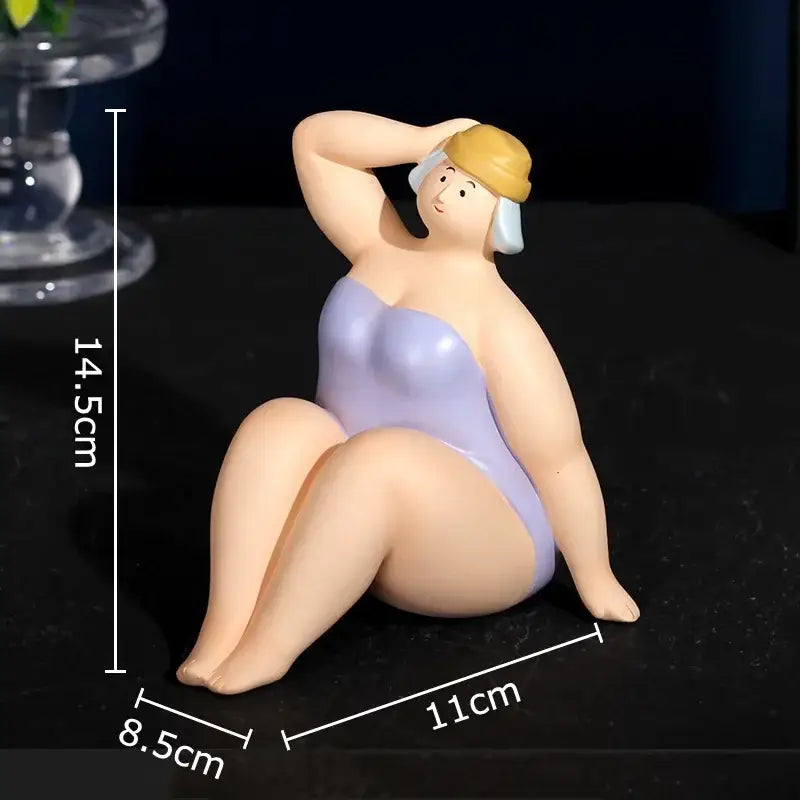 Stylized resin sculpture of a woman in a lavender beach swimsuit and yellow swim cap as a desk ornament