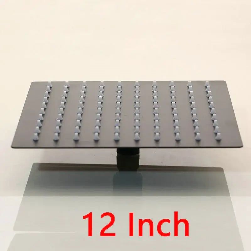 Super slim matte black 12-inch square shower head with black matte finish and evenly spaced nozzles for rainfall effect