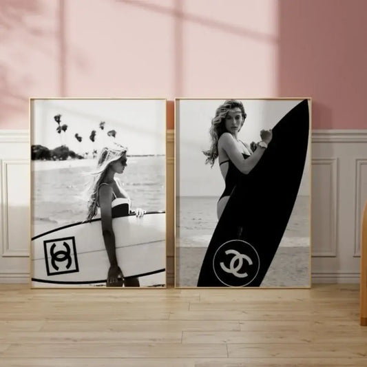 Two framed black and white photographic surfboard wall art prints featuring surfers with Chanel logos for teen room decor