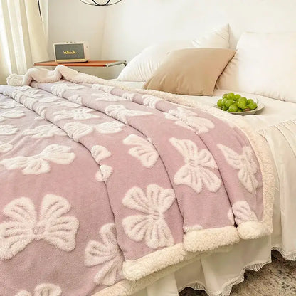 Pink plush fleece throw blanket with white embroidered bows and soft border complementing decorbites butterfly jacquard wool blanket