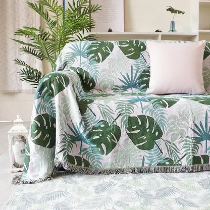 Teal and blue peacock knit sofa blanket with vibrant tropical leaf pattern and soft fringed edges for decorbites knit sofa