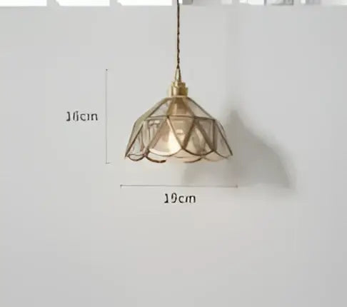 Teal blue glass pendant light with delicate brass hardware and lace-like petal-shaped shade for dining room decorbites blue glass pendant lights