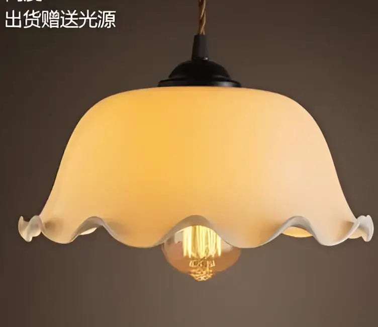 Cream-colored translucent glass pendant light with scalloped edge and exposed Edison bulb for decorbites blue glass pendant