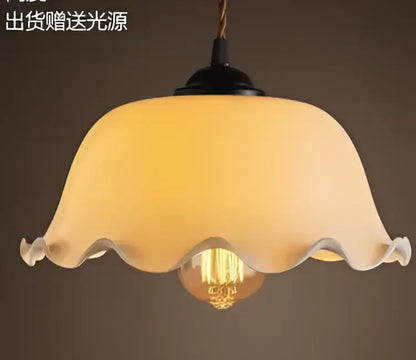 Cream-colored translucent glass pendant light with scalloped edge and exposed Edison bulb for decorbites blue glass pendant