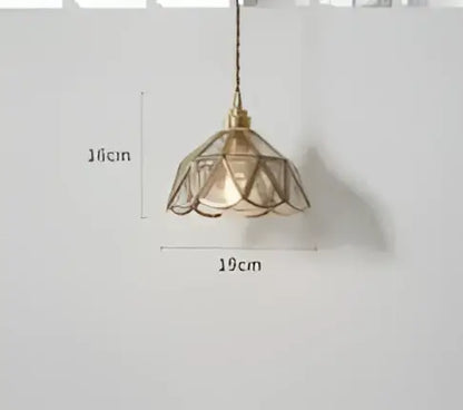 A teal blue glass pendant light with brass hardware and a delicate lace-like petal-shaped shade for dining room decorbites blue glass pendant lights